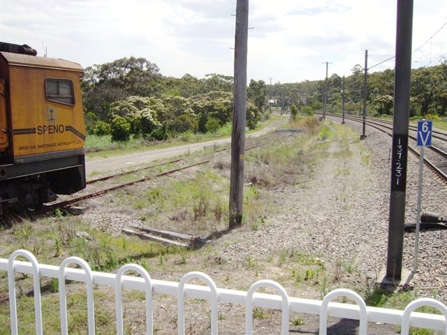 A view from the southern end (Sydney end) of Awaba Station. A rake of track maintenance vehicles are stabled on the former Wangi Wangi branch. A stop block is seen at the end of the truncated track.