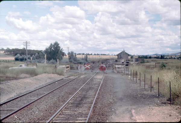 The view looking south from the station towards the goods shed, showing the manual gates.