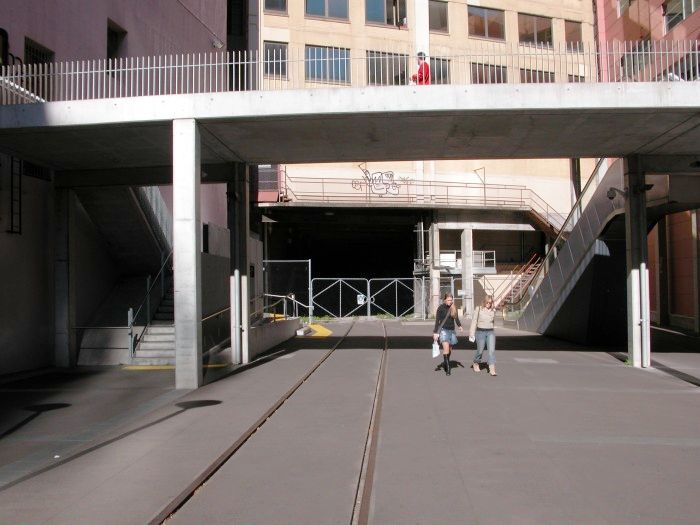 
The tunnel under the University of Technology building at Broadway
near Central Station. The tunnel was originally double tracked but
with both tracks overlapping so trains could not pass in the tunnel.
Now only one track is present. The line is a siding of Sydney Yard
leading to the Powerhouse Museum that is now part of a combined
public walkway and operating railway siding.
