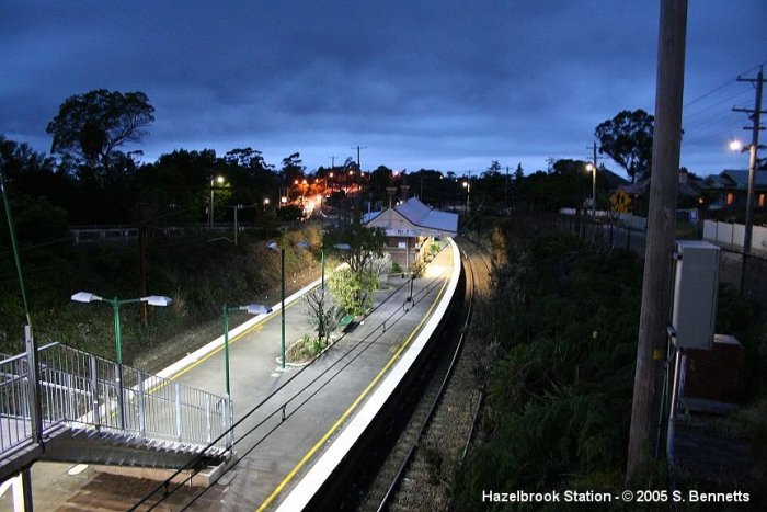 A photo of Hazelbrook Station taken just after sunset. The picture was taken facing towards Sydney looking down over platform 2 and Down Main from the road bridge over station.