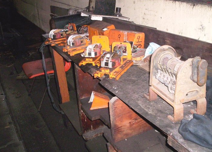 The electrician's bench with spare electric gear that make the levers release for for movement.