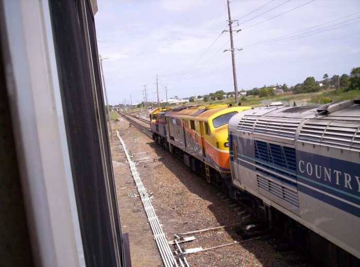An XPT set being hauled by a pair of locos past the signal box.