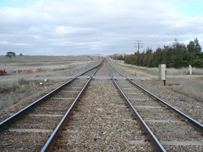 The view looking east towards the station location.  The side platforms were located several hundred metres beyond the level crossing.  A goods siding was located on the left hand side, extending back towards the crossing.