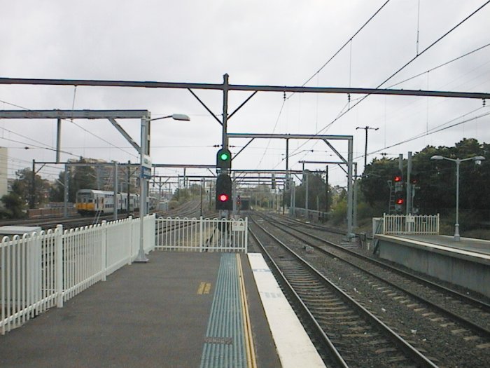 The view looking away from Sydney from the end of Platform 3. The Main North lines diverge to the right and also over the flyover (centre).  The Main South line goes straight ahead under the flyover, and also on the left of the photo.
