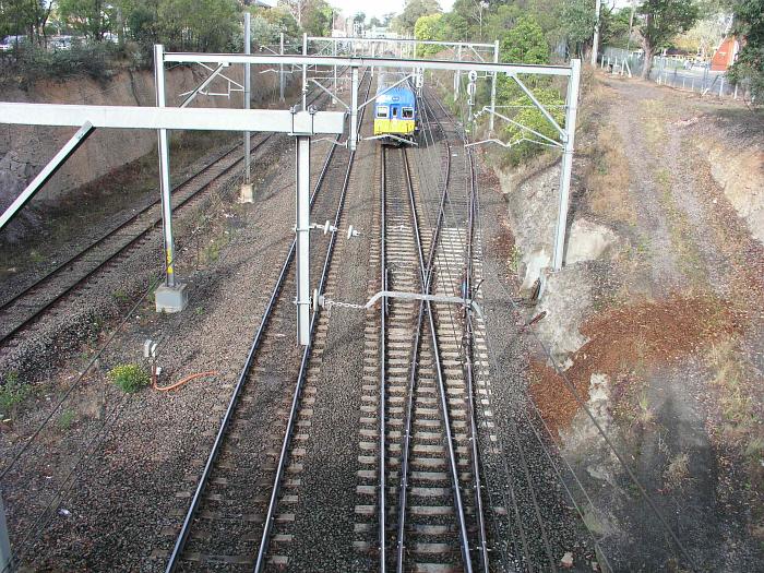
The view looking south as an inter-urban set approaches the station.  The
tracks on the outer left and right are the up and down relief lines.

