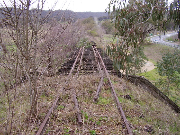 The only track remaining in this vicinity is that on the timber bridge.  A view looking east towards Tumut with the Snowy Mountain Highway seen on the right.
