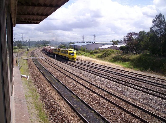 A view looking west from Hanbury Junction signal box of an SSR loco-hauled ballast train from Martins Creek Quarry and destined for Broadmeadow Yard.