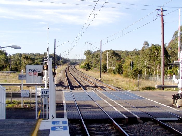 The view looking north at the level crossing with  Warnervale Road.