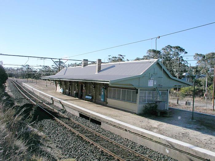 
The view looking west across at the station.  The near end of the building
was housed the signal box, as evidenced by the opening in the platform.
