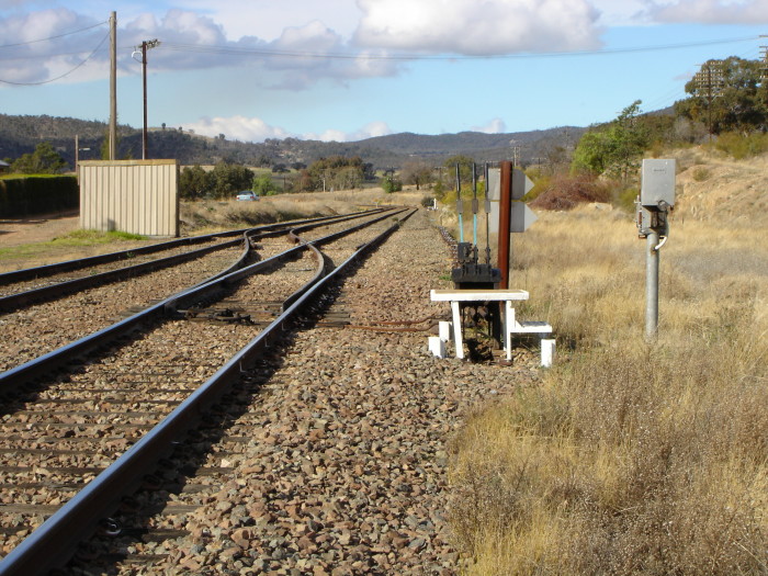 The view looking north. Only a staff hut and cross-over remain of the one-time station.  The platforms were located on either side of the tracks near where the car is parked.