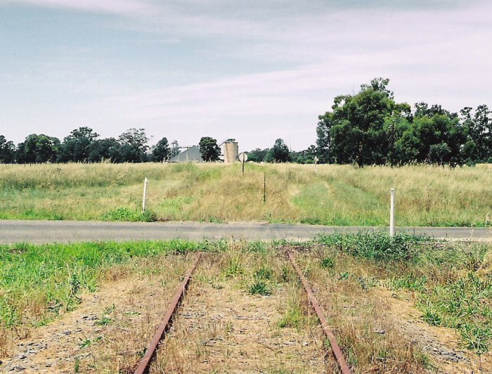 The view from the level crossing of the Balldale road, showing the rear of the stop block. The silo complex is clearly visible on the up side of the main line.