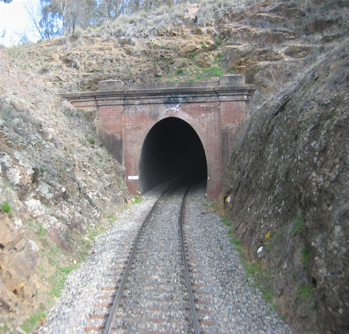 The northern portal of the tunnel. The tunnel is located on the southern end of a steep section of track, the Brooks Bank, that often required trains heading for Queanbeyan to use a banking engine.