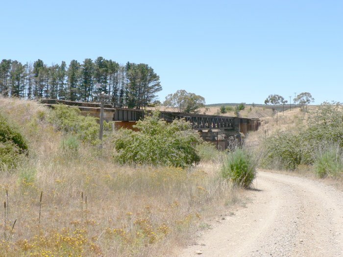 The eastern side of the nearby bridge over the road.