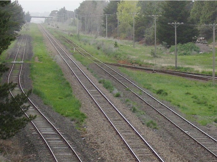 The only siding still in regular use along the Canberra branch line is that to the oil terminal.  A view from the Ipswich Street road bridge looking towards Queanbeyan with the line to the oil terminal heading right from the main line.