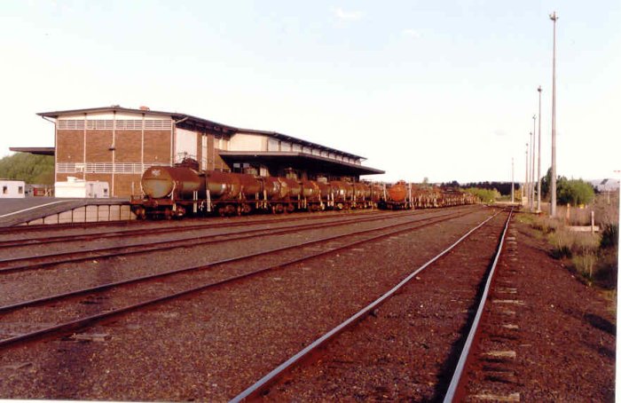 A view of the goods shed, with several oil tanks being stored in the adjacent sidings.
