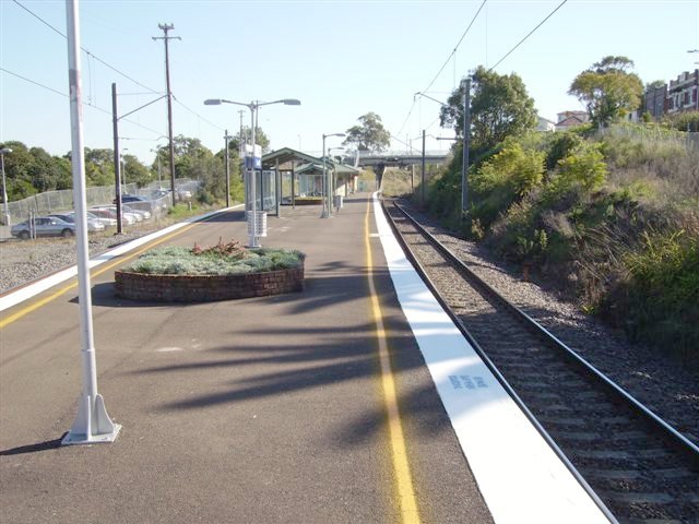 The island platform of Cardiff Station as seen from the Newcastle end looking towards Sydney. Passengers are reminded to travel in the rear 4 cars due to the length of this platform.