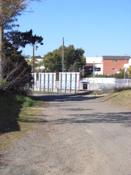 A view of the access road which covers the formation of the former Electricity Commission siding, looking back towards the station.