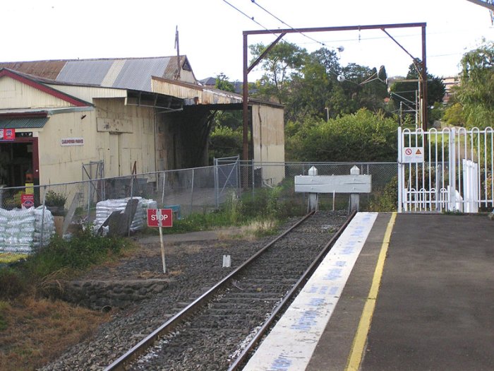 The awning overhanging from the eastern side of the Carlingford Produce building marks the location of the former produce siding. The overhead stauchions continue a fair way into the distance - about 150m - before the overhead is grounded just before Boundary Road.