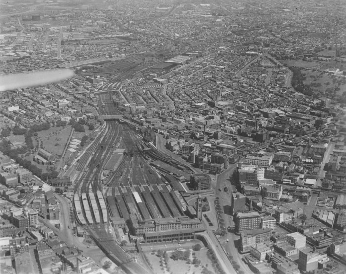 The view looking down from an aeroplane over the Central Station area. In the left foreground are the suburban platforms, with the country platforms on their right. Beyond the second overbridge is Redfern station.

A larger version of this photo is available <a href="/photos/special/central-aerial_photograph_large-oct1931.jpg">here</a>.
