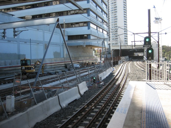 The construction work for the Chatswood-Epping line looking north from the current (temporary) platform. The two newly laid tracks shown on the left will take trains to Epping through the tunnel portal just beyond the concrete overbridge in the mid distance.