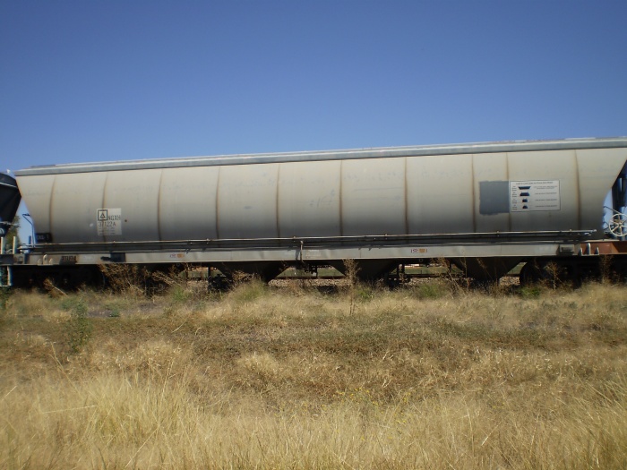 A wagon in a wheat train, being loaded in the silo siding.
