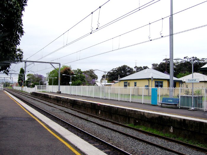 The view looking towards Sydney from up platform. A set of level crossings can be seen to the left edge of the image.