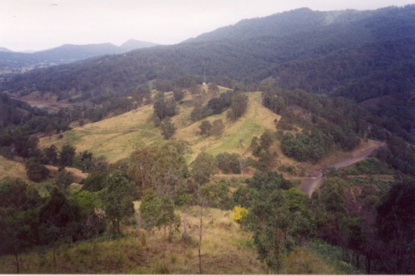 
A broad view of the Cougal border loop looking down the valley towards Kyogle.
Due to the steepness of the countryside, a series of tunnels were built
through the mountains giving the old steam trains enough height to cross over
the Border Ranges into Queensland.
