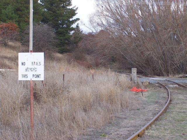 The view facing Goulburn at the end of the Crookwell yard. The sign on the leftis  no longer relevant with the replacement of the level crossing in March 2006.