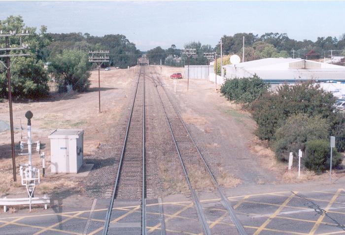 The view from the footbridge of the level crossing and lines south of the station.  The main south is on left and the start of the Corowa branch on the right. The remains of the now disconnected Holbrook branch is on the left behind the second telegraph pole.