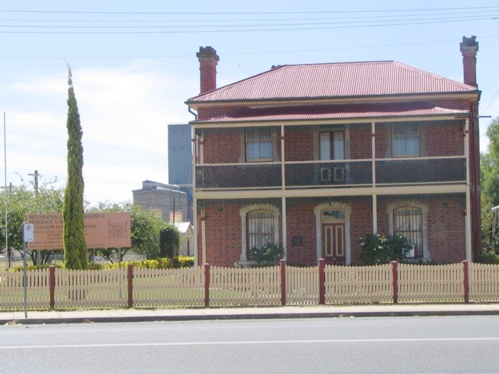 The restored station master's residence.  The line runs to the left and the station building is in the background.