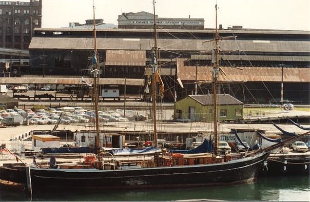 
The view looking west from the city side, showing a restored sailing ship
alongside the wharves.
