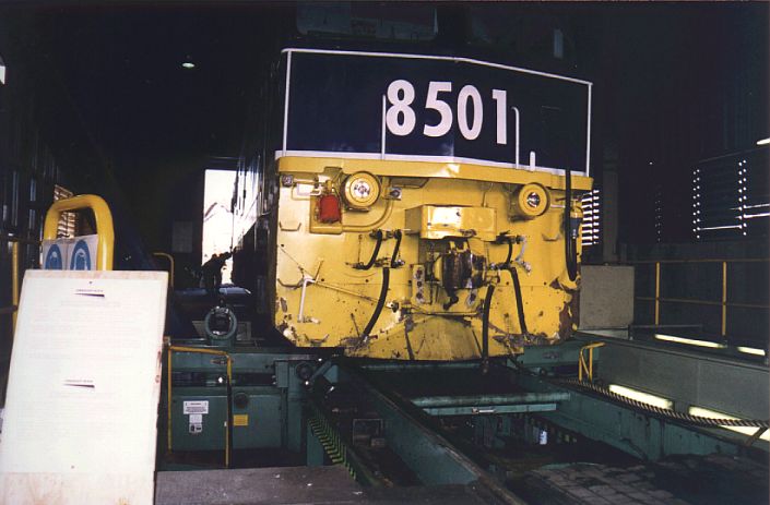 
A somewhat battered-looking class leader 8501 sits on the wheel lathe.
The wheel lathe is used by all types of locomotives to remove defects
(wheel scale, flat spots etc) from wheels.
