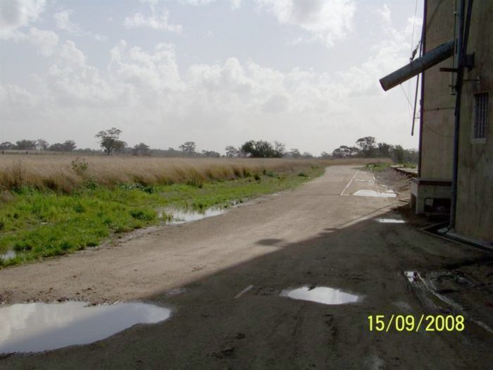 The view looking along the former grain siding as it passes the silo.