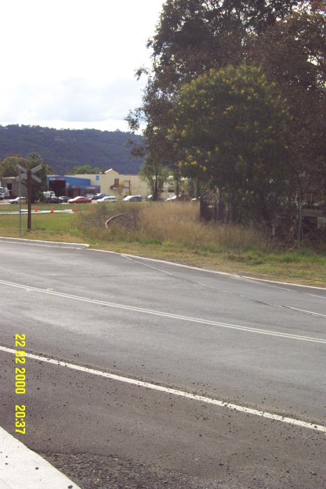 After crossing the road, the siding curves around to the north.