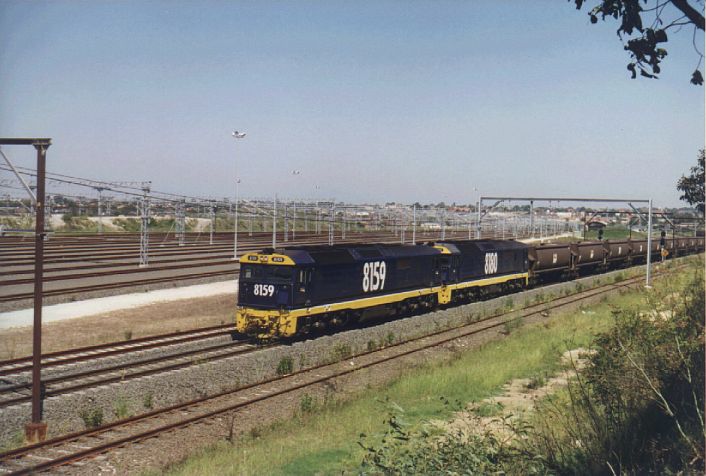 
This photos shows 8159/8180 with an empty coal train on the running lines
next to an empty Enfield Yard.  At this time the yard has not yet been
re-commissioned.
