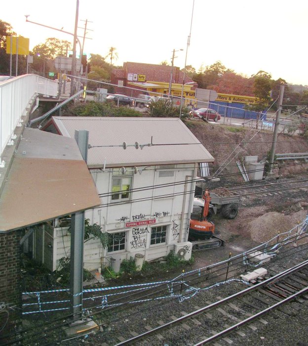 The signal box with adjacent earthmoving equipment.