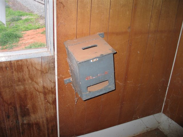 A wooden box is still mounted on the signal box wall.