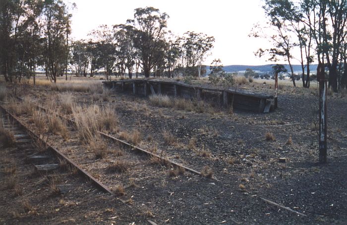 
This rotting timber platform is still present, although the track
which served it has been lifted.  The post in the left foreground is
a half-kilometre marker.

