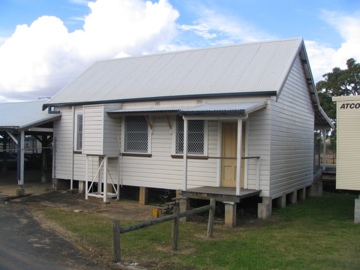 An old station building sits next to the modern structure.