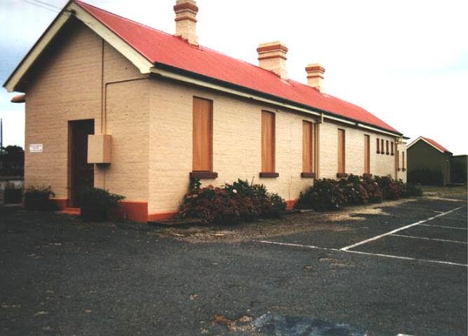
The boarded up windows on the road side of the station building.
