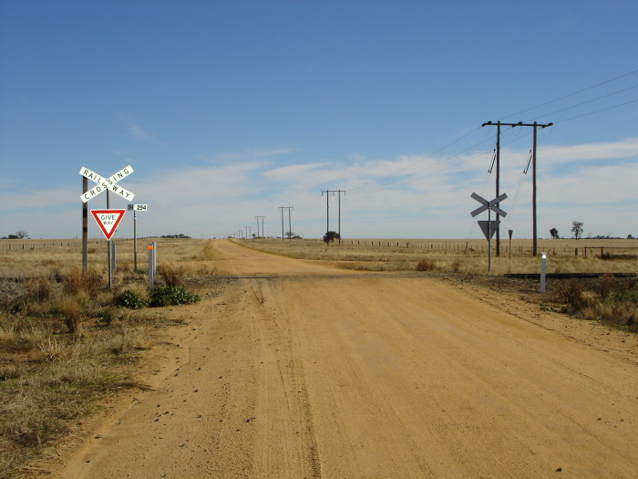 The level crossing adjacent to the station location.