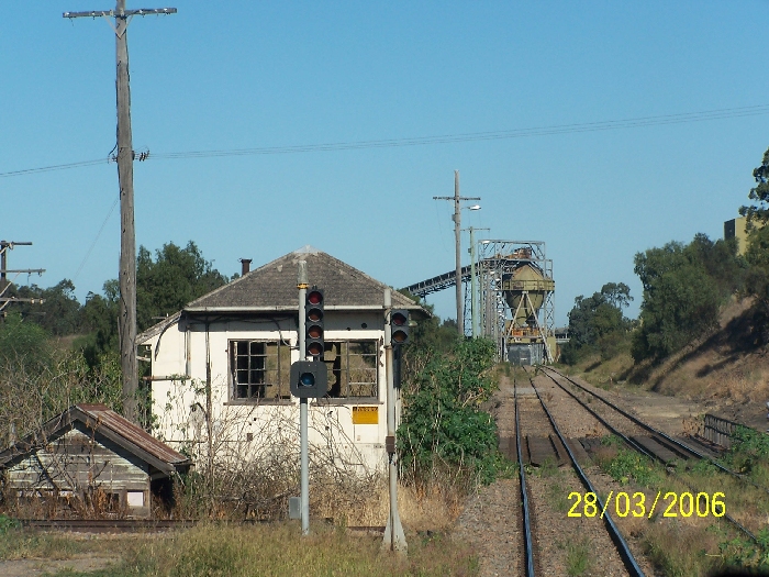 The view looking up the line towards the Hunter Valley Coal Loader.  In the foreground is the old Newdell Signal Box, that controlled the former sidings for the Liddell, Newdell and Durham Collieries. The lights in the foreground are loading lights for Liddell loading bin.