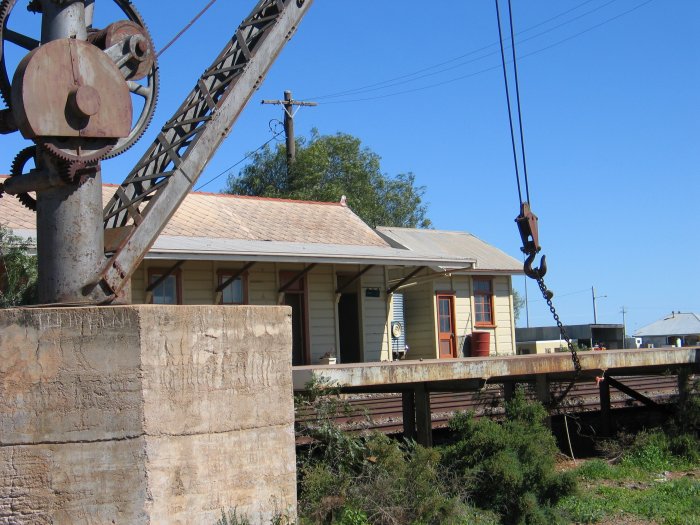 The jib crane sits idles, opposite the station.