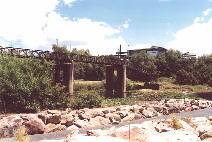 
The view of the Georges River bridge piers, looking back in the direction of
the one-time junction.  The structure behind the trees is Liverpool
station.
