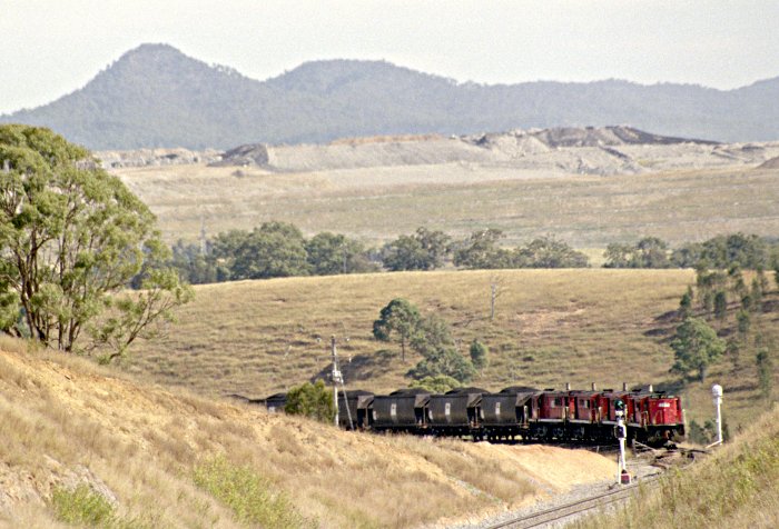 A loaded coal train headed by 4 48-class locos is climbing up to the junction.