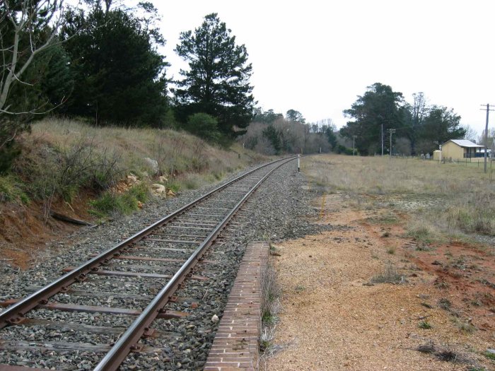 The view looking north from the station.  The small white post on the bank in the distance on the left of the track is a relocated railway sign.