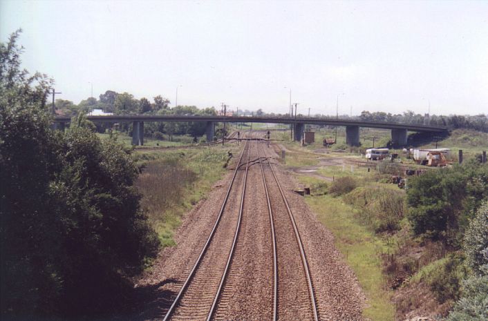 
Looking east towards Maitland Junctions.  The lines curving off in the left
distance are the start of the North Coast line.  Coming in from the right
is the start of the Cessnock Branch.
