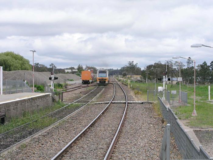 
The view looking north from the up and of the station.  A RIC work train
is refuged in te goods siding, and an Endeavour railset is heading north.
