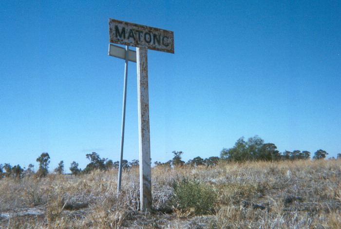 The platform at Matong still supports two station name signs but the better of the two faces the road rather than the tracks.