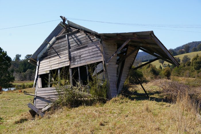 The passenger shelter is in the process of collapsing.